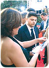 A Golden Globes show ticket with embedded RFID chip being scanned at front of red carpet.
